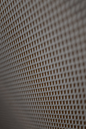 Close up of a perforated metal surface. Abstract background.の写真素材