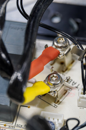 Electronic circuit board with multimeter, close-up. Electrical backgroundの写真素材