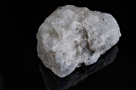 A raw moonstone fragment on a black background.