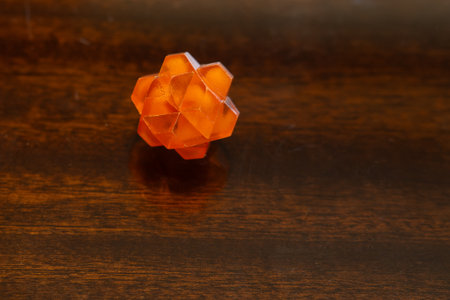 Small transparent orange plastic star used as a puzzle.の写真素材
