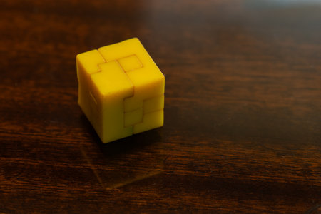 Small yellow plastic cube used as a puzzle.の写真素材