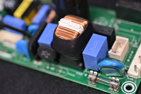 Close-up of brass parts of a coil on a printed circuit board.の写真素材