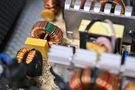 Close-up of brass parts of a coil on a printed circuit board.