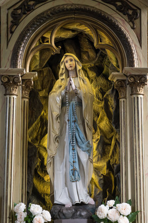 The Virgin Mary carved in a Christian altar in a church.の写真素材