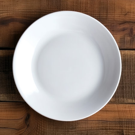 Empty white plate or dish on wooden table with top view background. High quality photoの素材