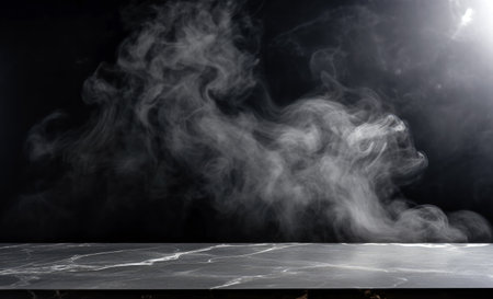 Smoke from incense sticks on a empty black stone table with black background. High quality photoの素材