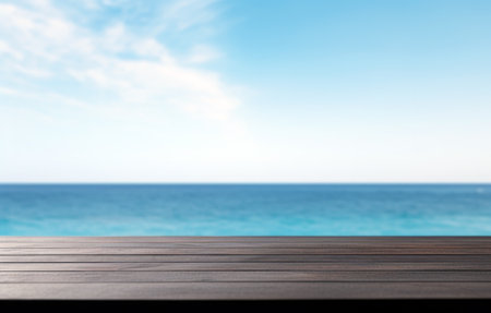 Black wooden table top and blur seascape and blue sky of the background. High quality photoの素材