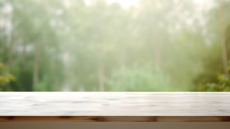 Empty wooden table in a misty forest blurred background for product display. High quality photoの素材