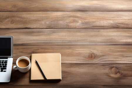 Modern workplace with laptop, notepad and coffee cup on wooden table top view background. High quality photoの素材