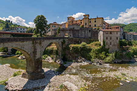 The old town of Castelnuovo di Garfagnana with the old bridge at the Tuscany Region in Italyの写真素材