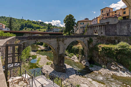 Old bridge over the River at the old town of Castelnuovo di Garfagnana at the Tuscany Region in Italyの写真素材