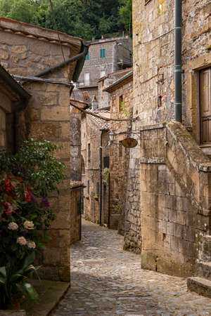 Narrow street at the old town of Sorano at the Tuscany Region in Italyの写真素材