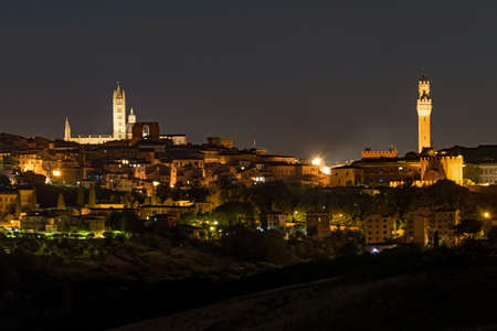 The skyline of Siena's old town at the Tuscany Region in Italy at nightの写真素材
