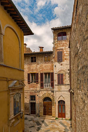 Narrow street of the old town of Colle di Val d'Elsa at the Tuscany Region in Italyの写真素材