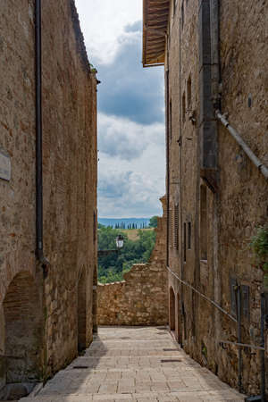 Narrow street of the old town of Colle di Val d'Elsa at the Tuscany Region in Italyの写真素材