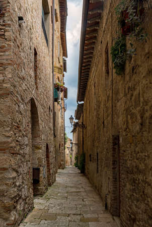 Narrow street of the old town of Colle di Val d'Elsa at the Tuscany Region in Italyの写真素材