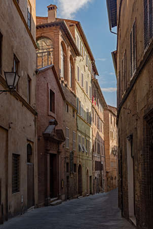 Narrow street at the old town of Siena, Tuscany Region in Italyの写真素材