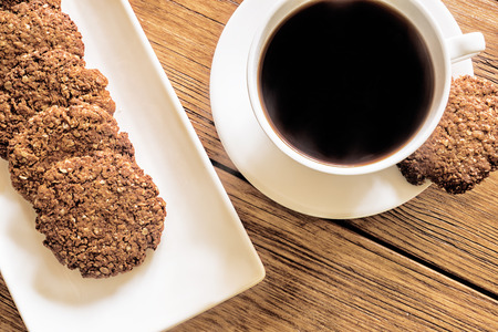 Oatmeal cookies and coffee on the wooden tableの写真素材