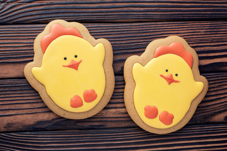 Glazed Easter gingerbread on a dark wooden tableの写真素材