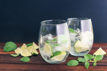 Drink with ice in a glass cup with a slice of lemonの写真素材