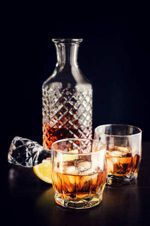 Drink in a glass decanter and two glassesの写真素材