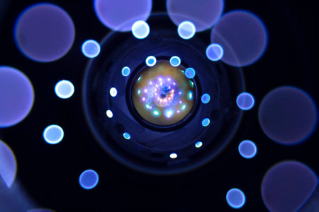 Closeup of a camera lens with blue bokeh lights.