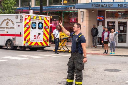 Chicago, IL - October 6th, 2021: A fireman helps direct traffic after a construction pile driving...