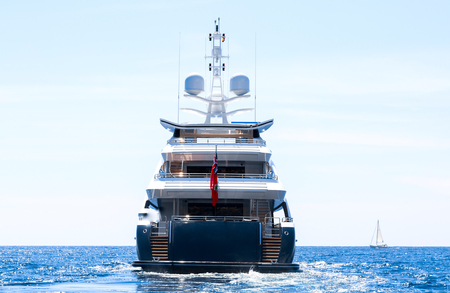 Large private motor yacht under way out at sea, back viewの写真素材