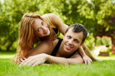 Happy guy and the girl on a grassの写真素材