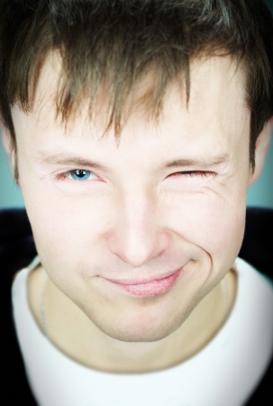 The guy smiles and winksの写真素材