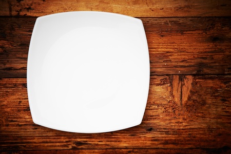 White plate on a wooden tableの写真素材
