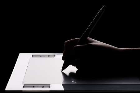 Graphic tablet, hand and featherの写真素材