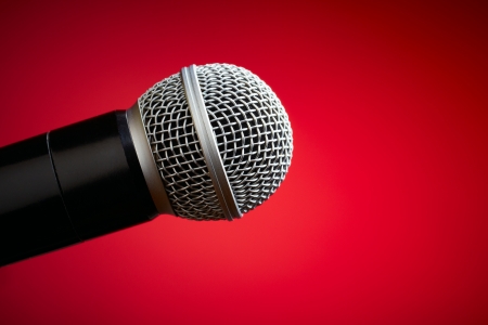 Professional microphone on red backgroundの写真素材