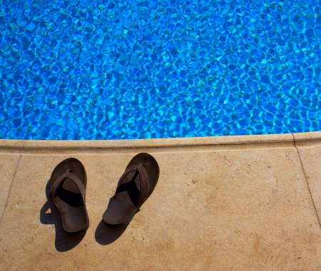 slippers on the edge of the pooの写真素材