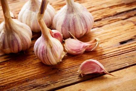 garlic on a old boardの写真素材