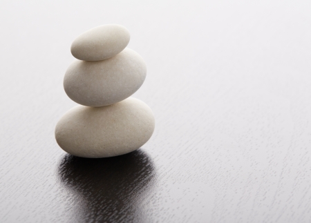 Zen stones on a wooden tableの写真素材