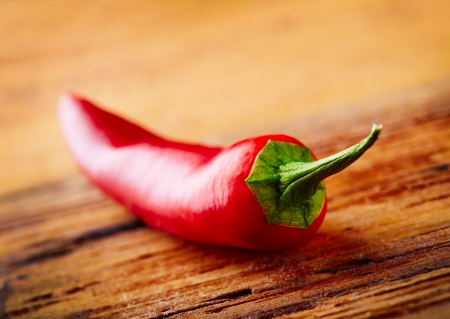 Chili pepper on wood table close-upの写真素材