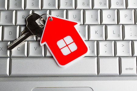 House key on laptop keyboardの写真素材