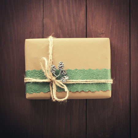 Handmade christmas gift box on wooden table, close-up