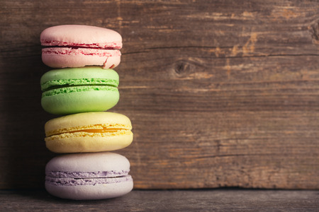 Macaroons on wood background with copy spaceの写真素材
