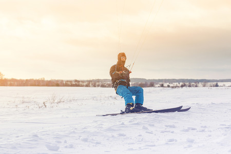 The skier goes on the snow field with kyte in winterの写真素材