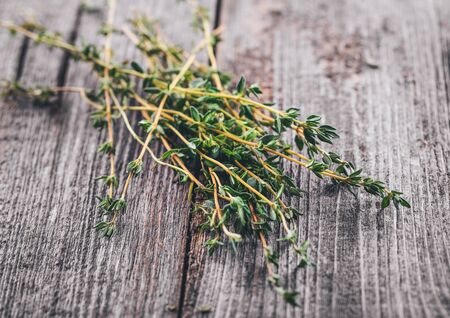 Thyme on wood background close-up. Top view