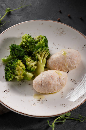 Diet turkey cutlets with broccoli side dish in white plate on gray tableの写真素材