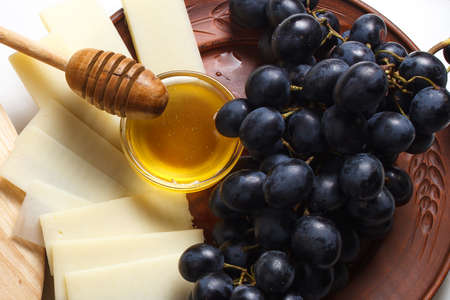 Cheese plate with fruit and honey.の写真素材