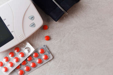 Pills and blood pressure meter on the table. Medical concept. Copy spaceの写真素材