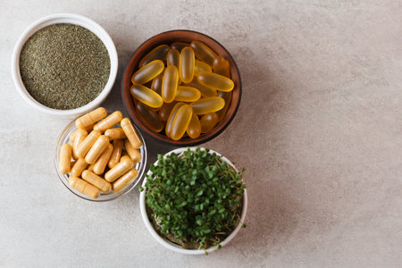 Microgreens, herbal powder and pills on a gray background. copy spaceの写真素材