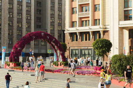 Moscow, Russia, 08.14.2022: People walk along the street decorated with floral decorations.のeditorial素材