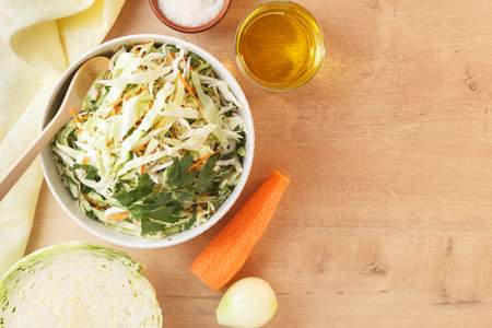 healthy vegan bowl of vegetable salad for lunch. Cabbage, carrots, parsley, onion, olive oil. copy spaceの写真素材