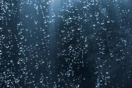 Rain drops on the glass on a blue background. Design Elementの写真素材