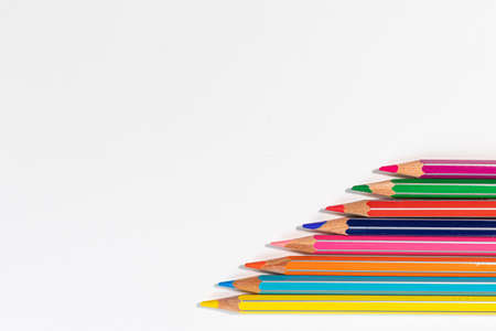 colorful crayons aligned making colorful lines on a white background with copy spaceの写真素材